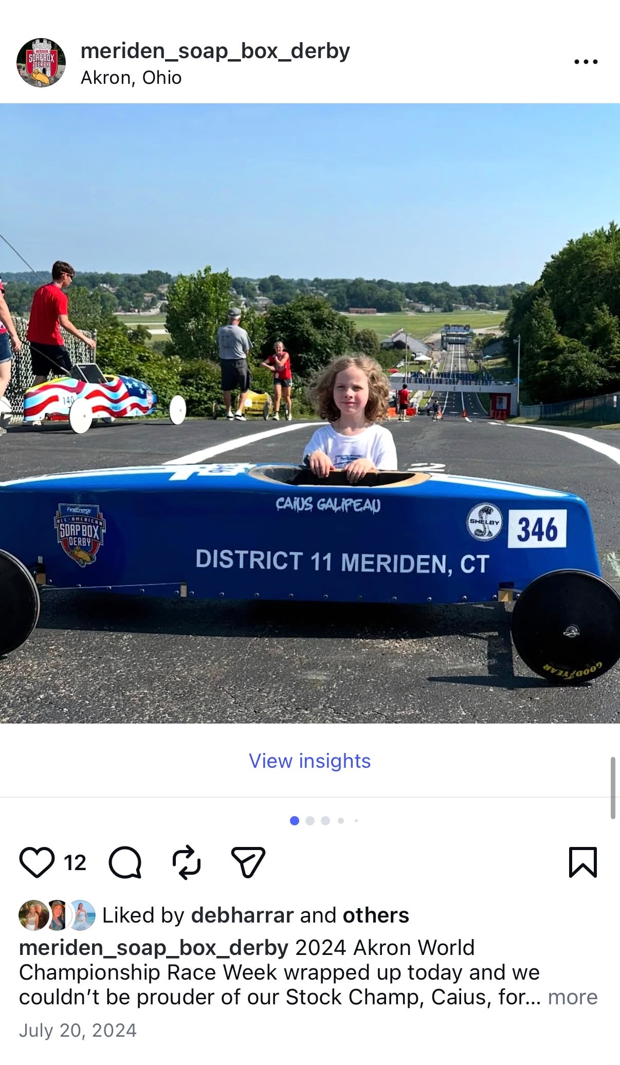 Meriden Soap Box Derby — child in blue soap box derby car racing